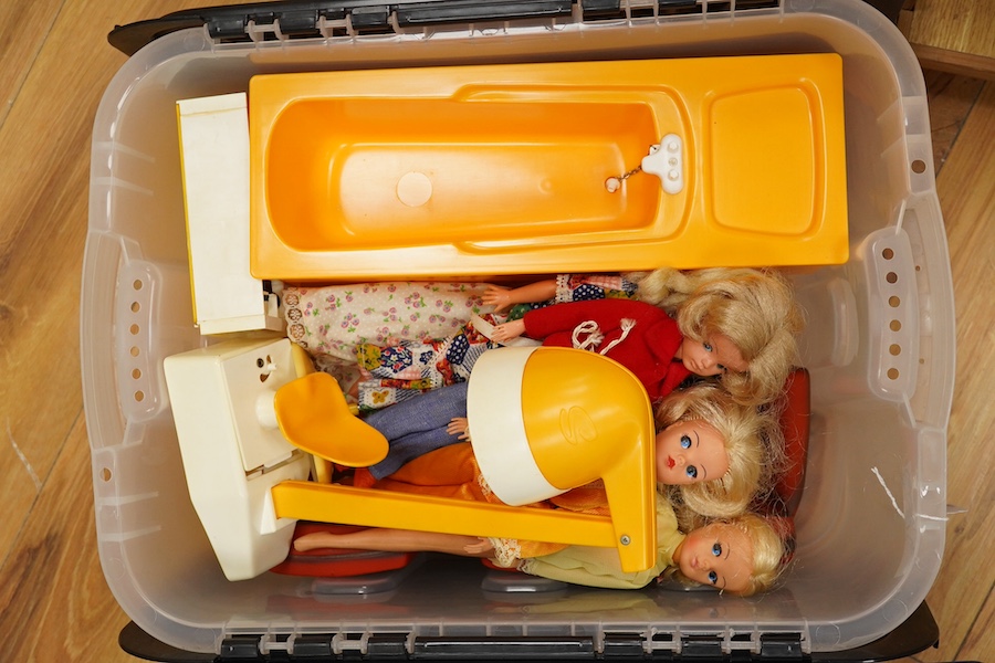 A collection of 1960s-80s Sindy dolls and accessories, including; five dolls, an early plywood and hardboard caravan, a large selection of clothing and accessories, furniture, house fittings, including a shower, wardrobe